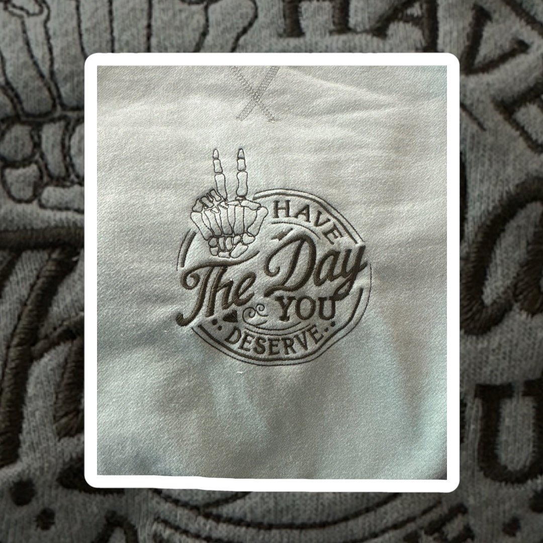 "Have the day you deserve" embroidered crewneck.